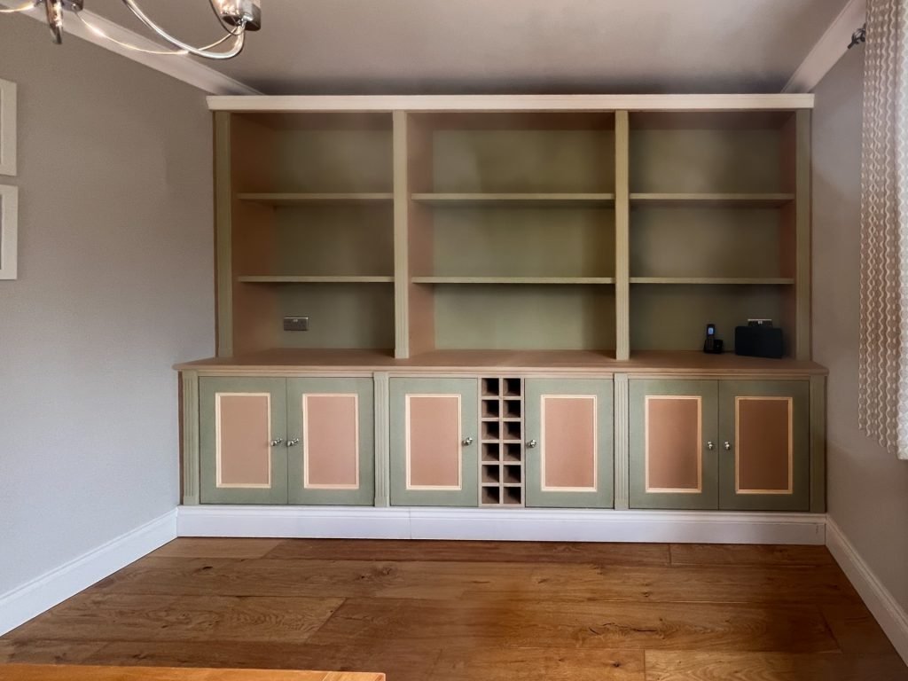 Bespoke built-in shelving and cabinetry with framed panel doors