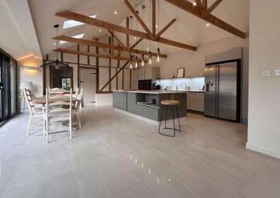 Open-plan kitchen with a large island and a vaulted beamed ceiling