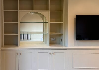 Bespoke alcove shelving and cabinetry around a wall-mounted TV