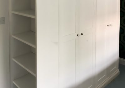 Tall white built-in storage cupboard