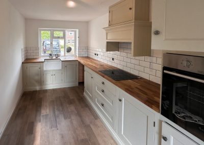 Shaker kitchen with pale units and timber worktops