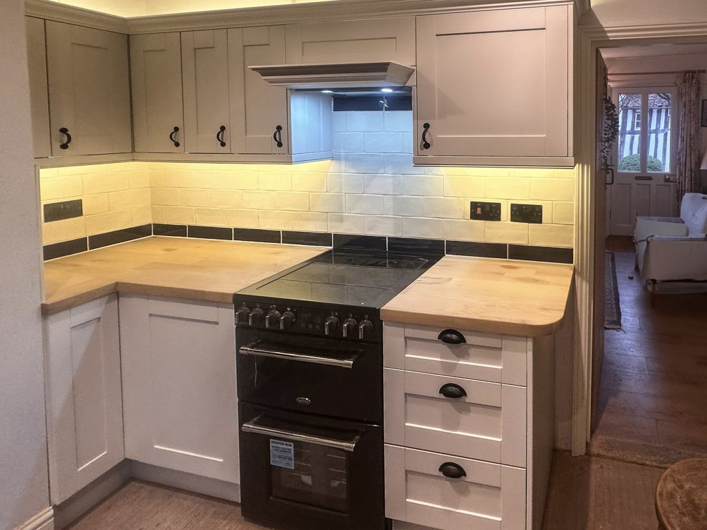 Renovated kitchen with pale shaker units and under-cabinet lighting