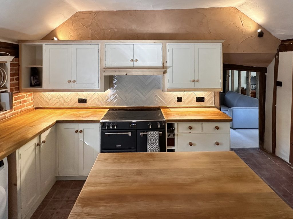 Renovated kitchen with a central island and timber worktops