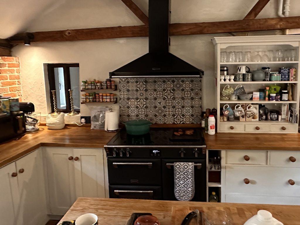 Traditional kitchen before renovation, with cream units and a range cooker